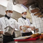 chef cooking in kitchen with safety equipment